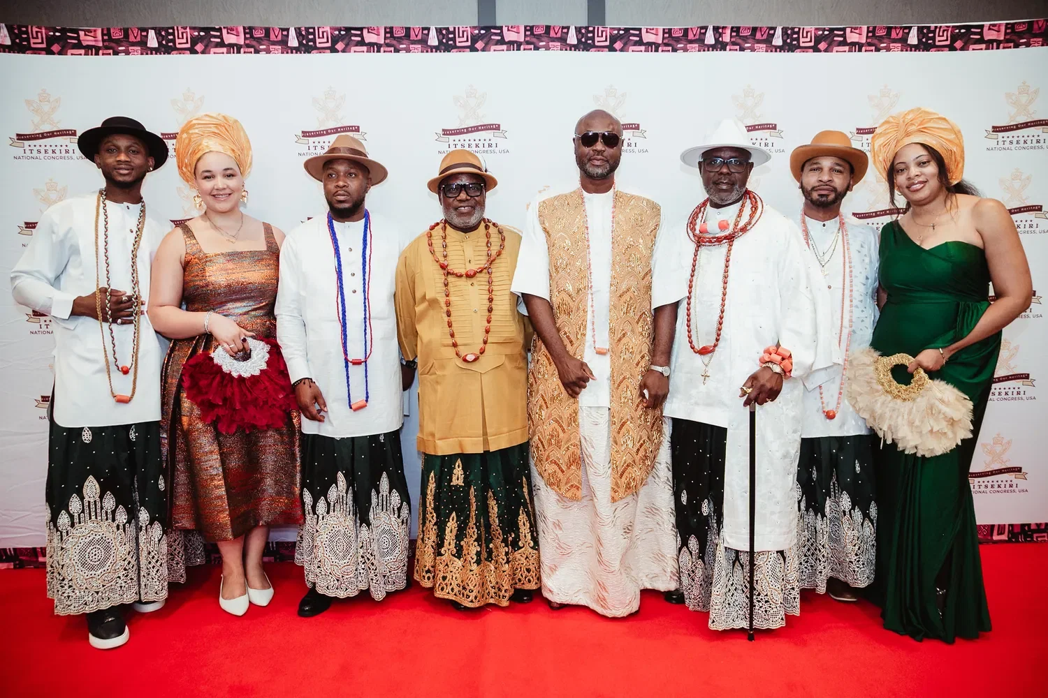 Members in matching wrappers and coral beads on the red carpet, Convention 2026, San Francisco
